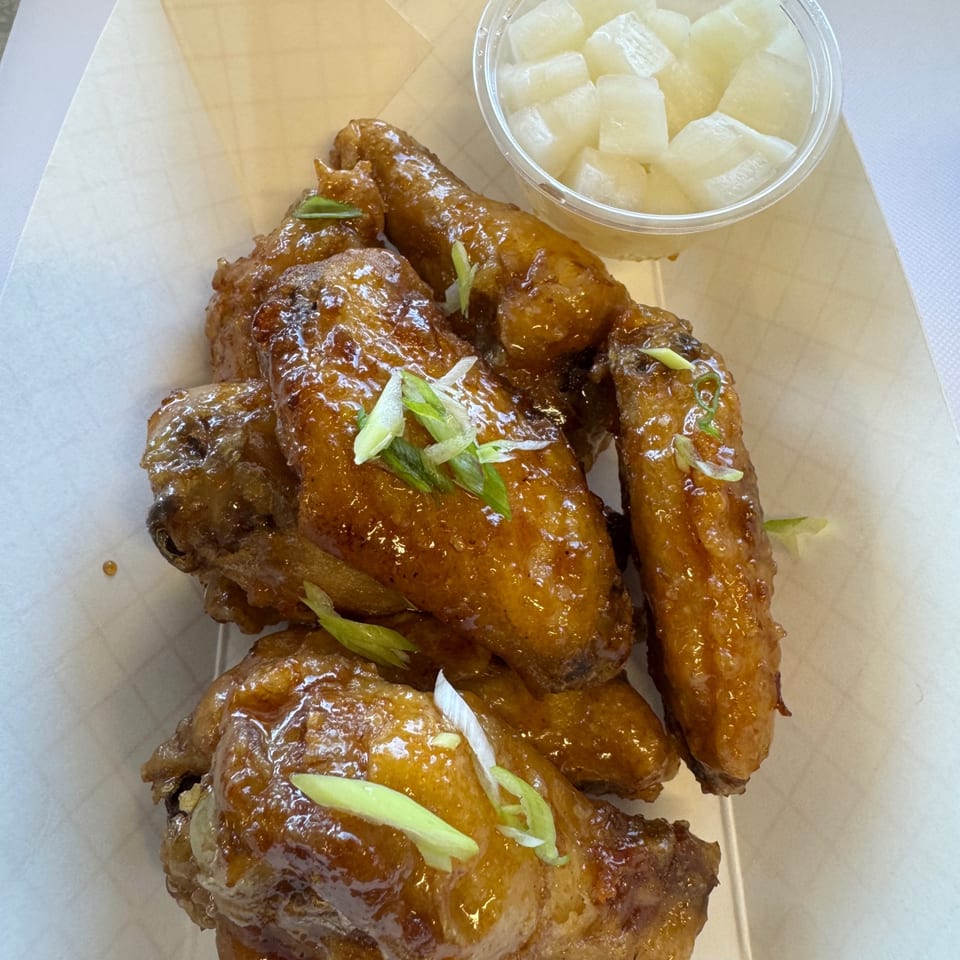 Glazed wings with sliced green onions
